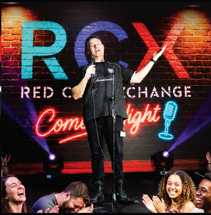 Comedian performing on stage at RCX comedy night